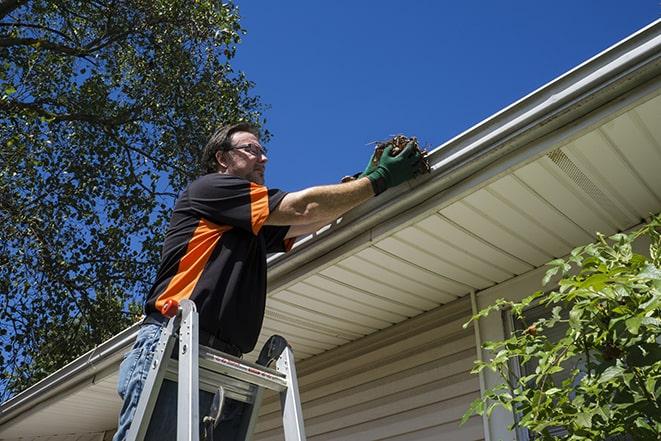 an experienced handyman fixing a gutter issue in South Barrington, IL